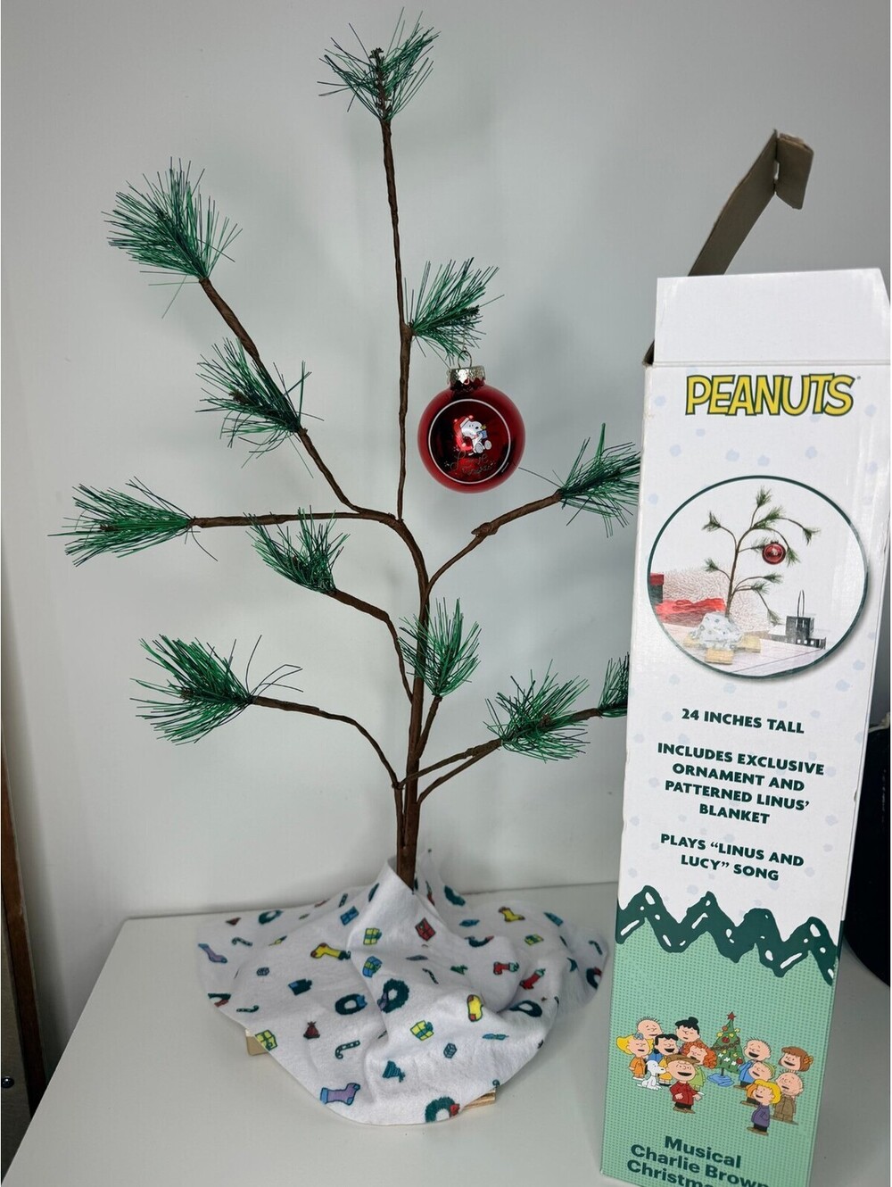 Peanuts musical Charlie Brown Christmas tree with Snoopy ornament and blanket